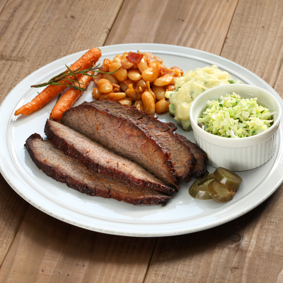 view of sliced cooked brisket dinner with sides to show can you cut a brisket in half