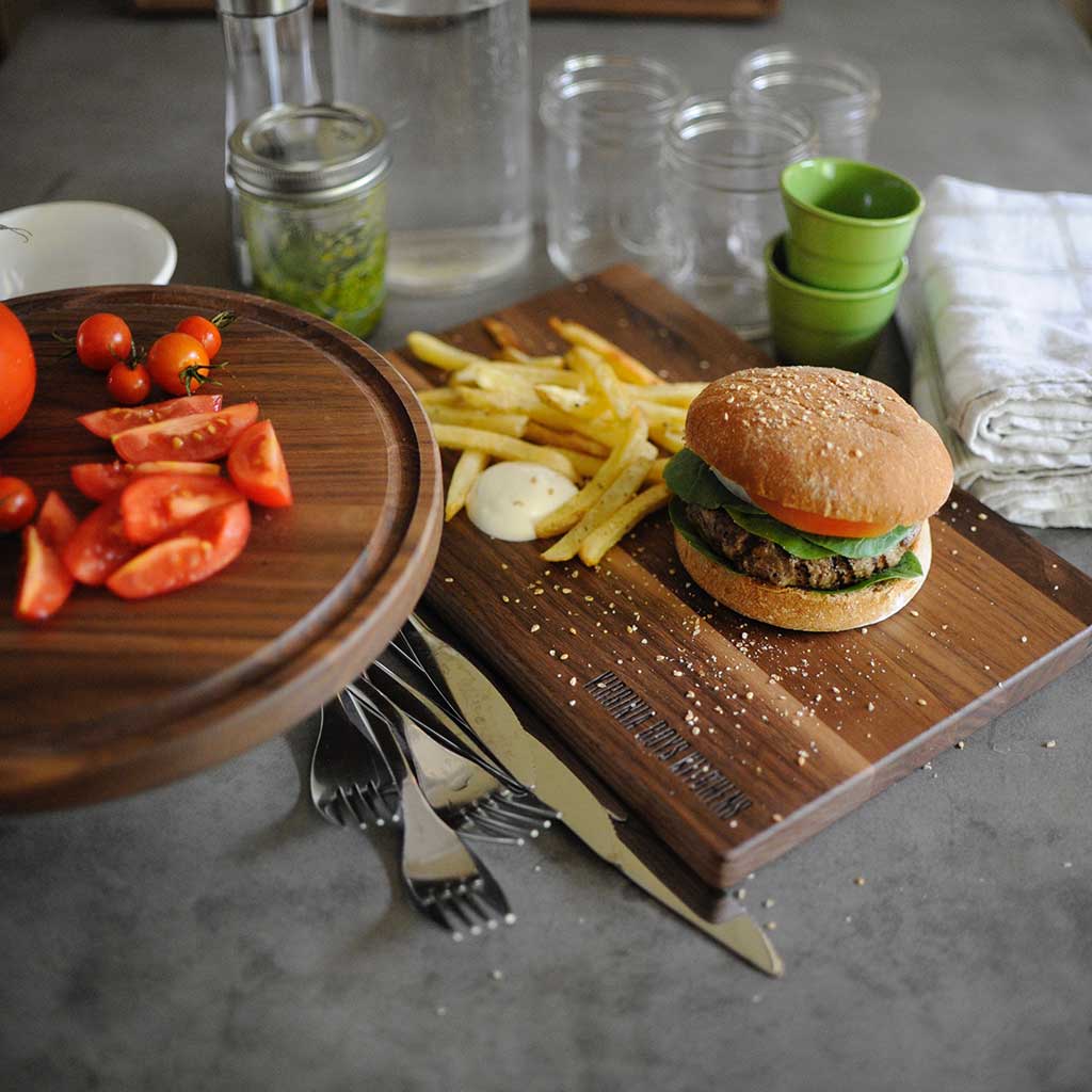 burger and fries on a walnut cutting board for cherry vs walnut cutting board