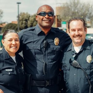 three police officers standing together and smiling - find out the best gift for police officers