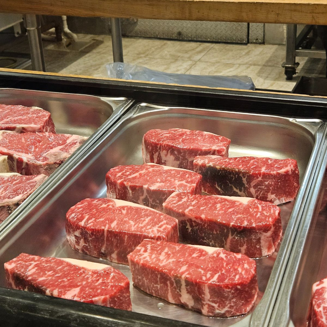 Ribeye steak cuts over a tray at the butcher shop