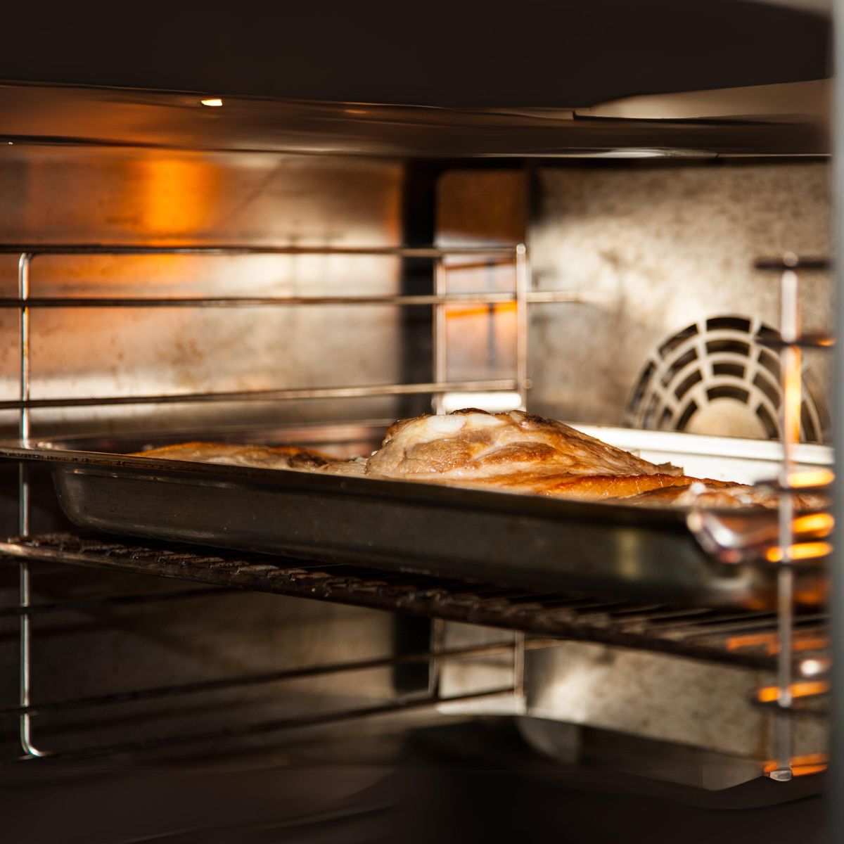 Steak over a tray in an oven