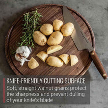 Round knife friendly cutting board with garlic, rosemary, and potatoes